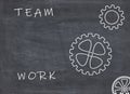 Teamwork concept with cogwheels and text on blackboard background Royalty Free Stock Photo
