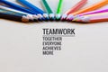 Teamwork concept. group of color pencil on brown background with word Teamwork, Together, Everyone, Achieves and More