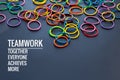 Teamwork concept. group of colorful rubber band on black background with word Teamwork, Together, Everyone, Achieves and More Royalty Free Stock Photo