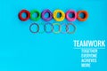 Teamwork concept. group of colorful rubber band on blue background with word Teamwork, Together, Everyone, Achieves and More Royalty Free Stock Photo