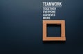 Teamwork concept. group of wooden square on the black backgrounds with word Teamwork, Together, Everyone, Achieves and More