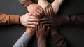 Teamwork concept. Multiethnic people joining hands on black background