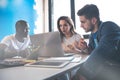 Teamwork concept.Young creative coworkers working with new startup project in modern office.Group of three people Royalty Free Stock Photo