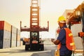 Forklift trucks workers can remotely control the loading of containers at high altitudes using radio communication to work. Royalty Free Stock Photo