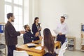 Group of smiling business people applauding to coworker after presentation of new project in office Royalty Free Stock Photo