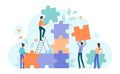 Teamwork cooperation to connect puzzle solution, tiny people holding jigsaw piece to fit Royalty Free Stock Photo
