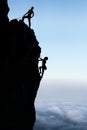 Teamwork couple climbers in silhouette