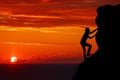 Teamwork couple hiking help each other trust assistance silhouette in mountains, sunset. Teamwork of man and woman hiker helping e Royalty Free Stock Photo