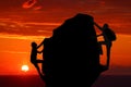 Teamwork couple hiking help each other trust assistance silhouette in mountains, sunset. Teamwork of man and woman hiker helping e Royalty Free Stock Photo