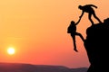 Teamwork couple hiking help each other trust assistance silhouette in mountains, sunset. Teamwork of two men hiker helping each ot Royalty Free Stock Photo