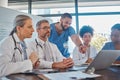 Teamwork, diversity and doctors in a meeting planning a surgery strategy in collaboration together on laptop in an Royalty Free Stock Photo