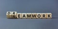 Teamwork and dream work symbol. Turned wooden cubes and changed the word `dreamwork` to `teamwork`. Beautiful grey table, grey Royalty Free Stock Photo