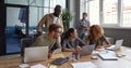 Teamwork. Group of young happy multicultural business people working together in modern office, communicating and Royalty Free Stock Photo