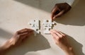 Teamwork hands assembling white jigsaw puzzle Royalty Free Stock Photo