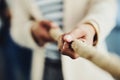 Teamwork, hands and tug and war while joining forces and pulling a rope for battle against competitors. Closeup of Royalty Free Stock Photo