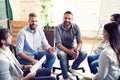 Teamwork is a key to success. Business people in smart casual wear talking and smiling while having a brainstorm meeting Royalty Free Stock Photo