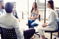 Teamwork is a key to success. Business people in smart casual wear talking and smiling while having a brainstorm meeting Royalty Free Stock Photo