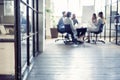 Teamwork is a key to success. Business people in smart casual wear talking and smiling while having a brainstorm meeting Royalty Free Stock Photo