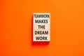 Teamwork makes the dream work symbol. Concept words Teamwork makes the dream work on wooden blocks on a beautiful orange table Royalty Free Stock Photo