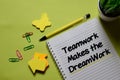 Teamwork Makes The Dreamwork write on a book isolated on office desk