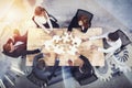 Teamwork of partners. Concept of integration and startup with puzzle pieces and gear overlay. double exposure Royalty Free Stock Photo