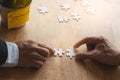 Teamwork, partners, connection concept. Hands of two businessmen merging jigsaw puzzle on the working table