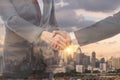 Teamwork, partnership and success concept. Double exposure of business handshake for successful of investment deal and city night Royalty Free Stock Photo