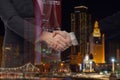 Teamwork, partnership and success concept. Double exposure of business handshake for successful of investment deal and city night Royalty Free Stock Photo