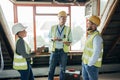 Teamwork, planning and engineers talking at construction site for repairs, maintenance or renovation. Tablet, clipboard