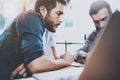 Teamwork process.Group of young coworkers working together modern coworking studio.Young people making conversation with Royalty Free Stock Photo