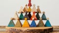 Teamwork Pyramid A pyramid structure built with geometric shapes, each representing a different race contributing to a common goal