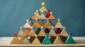 Teamwork Pyramid A pyramid structure built with geometric shapes, each representing a different race contributing to a common goal