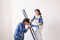 Teamwork, renovation and repair concept - Portrait of funny couple doing redecoration in apartment Royalty Free Stock Photo