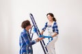 Teamwork, renovation and repair concept - Portrait of funny couple doing redecoration in apartment Royalty Free Stock Photo