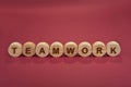 Teamwork sign on a wooden circles on a red