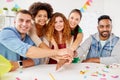 Happy business team at office party holding hands Royalty Free Stock Photo