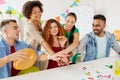 Happy business team at office party holding hands Royalty Free Stock Photo