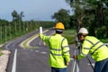 Teamwork of surveyor engineers worker making measuring with theodolite on road works. survey engineer at road construction site, Royalty Free Stock Photo