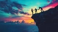 Teamwork symbolized silhouetted figures shake hands on cliff at sunset against colorful sky Royalty Free Stock Photo