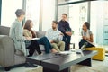 Teamwork, tablet and employee talking on sofa for communication, collaboration and conversation in office. Planning