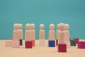 Teamwork, teambuilding mockup, copy space. Company structure. Wooden figures stands on colorful cubes, place for text