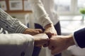 Closeup hand together of business team bumping fist jointing standing in office