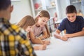 Teenagers students sitting in the classroom and writing. Royalty Free Stock Photo