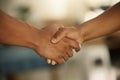 Teamwork, trust and support between a colleague, coworker or business partner. Closeup of two people sharing a hand