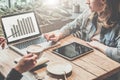 Teamwork, two young business woman sitting at table,drinking coffee and working online. Royalty Free Stock Photo