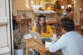 Teamwork. Two young startuppers sitting in cafe,