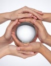 Teamwork and Vision - Hands Around a Crystal Ball Royalty Free Stock Photo