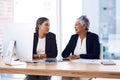 Teamwork is vital to getting to their goals. two businesswomen working together on a computer in an office. Royalty Free Stock Photo