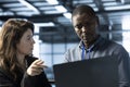 Teamworking coworkers in data center workspace using automation tools on tablet Royalty Free Stock Photo