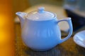 Teapot on a bar table against a blurred background